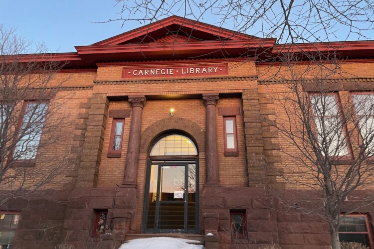 View of the front entrance to the library building, with blue sky above
